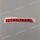 Emblemat Honda na dolną owiewkę, lewa strona