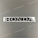 Under cowl HONDA emblem, right side