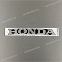 Under cowl HONDA emblem, left side