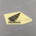 Front side cover wing emblem, left side