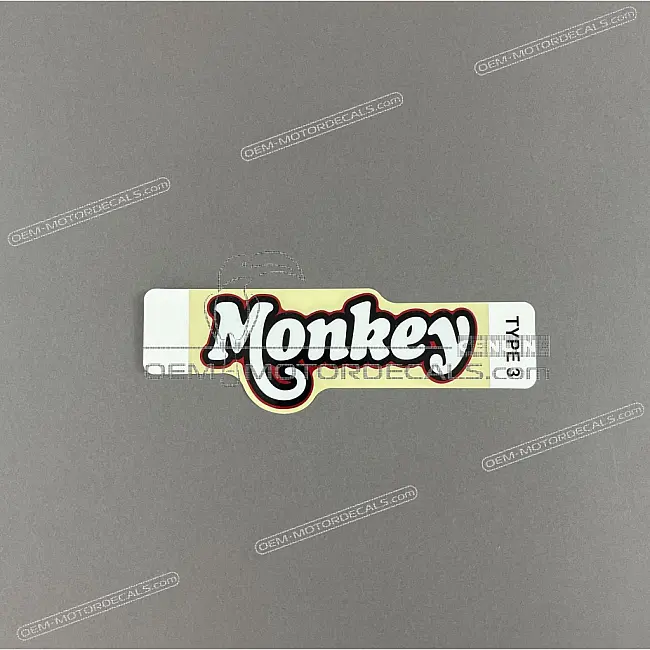 Honda Monkey Naklejka MONKEY na pokrywę akumulatora lewa strona OEM 86641K0FT00ZB Oryginalna fabryczna grafika
